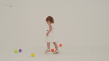 Little short hair girl plays toys with little sister wearing diaper
