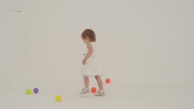 Little short hair girl plays toys with little sister wearing diaper