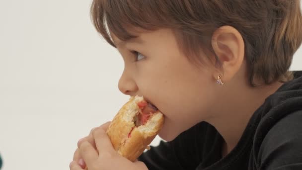 Short Haired Little Girl Eats Hot Dog Slow Motion — Stock Video