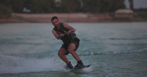 Wakesurfer Rider Ombord Sjö Närbild Teal Wakeboard Filmad Vid Solnedgången — Stockvideo