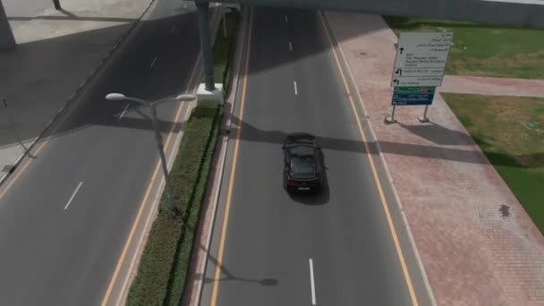 无人驾驶飞机在被棕榈树环绕的路上射击汽车的运动 — 图库视频影像