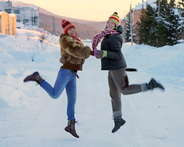 Girls are jumping on a winter road — Stock Photo, Image