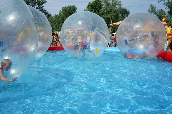 Children riding in a zorb balls. — Stock Photo, Image