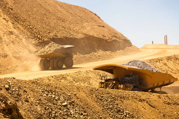 Huge dump trucks loaded with mineral  in a copper mine in Chile.