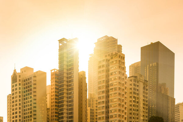 Sunset behind skyline of apartment buildings in the residential neighborhood of Chung Wan at Central Hong Kong, China.