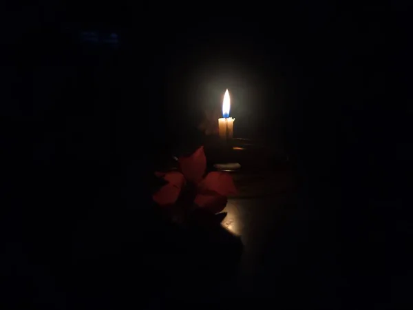 Close Photo Candle Flame Seen Dark Room Frangipani Flowers Next — Stok fotoğraf