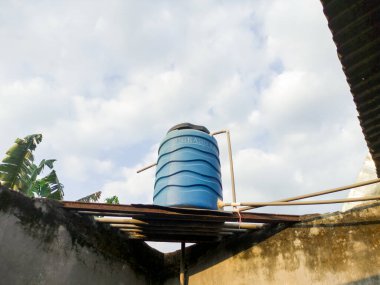 Malang, Endonezya - 22 Haziran 2022: 500 litre su tankı, duvarda büyük bir su tankı