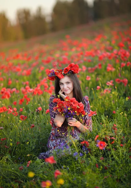 Beautiful girl pose in red flower field — Stock Photo, Image