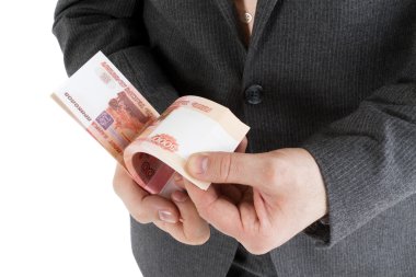 stack banknotes of 5000 rubles in male hands clipart