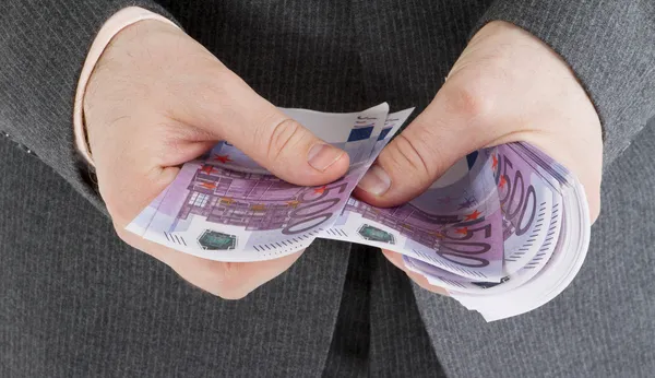 Stack banknotes of 500 euro in male hands — Stock Photo, Image