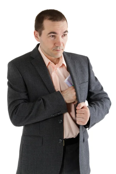 Man puts a stack of banknotes in a pocket — Stock Photo, Image