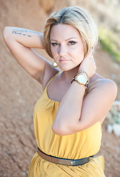 The beautiful young girl in a gold dress — Stock Photo, Image