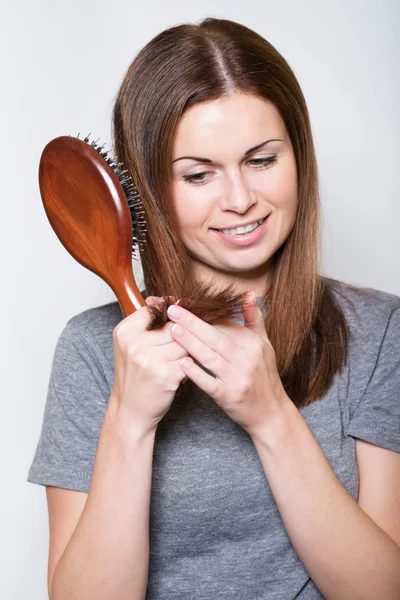 Young brunette beautiful woman combing long hairs — Stock Photo, Image