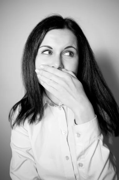 Woman smiles, covers a mouth with a palm — Stock Photo, Image