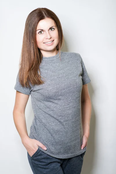 Beautiful young woman smiling on white background — Stock Photo, Image