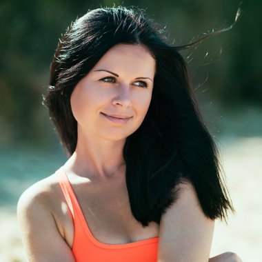 gülümseyerek mutlu bir kadın. Kumsalda dinlenmek