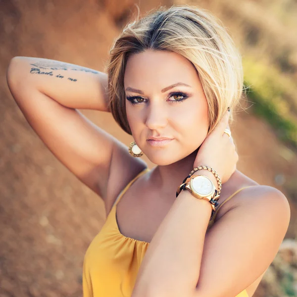 Portrait of the sexual blonde in a gold dress — Stock Photo, Image