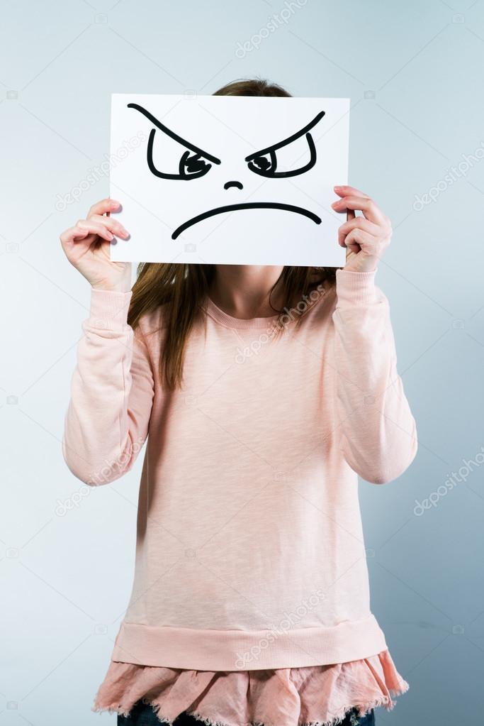 woman holding a cardboard with a angry face