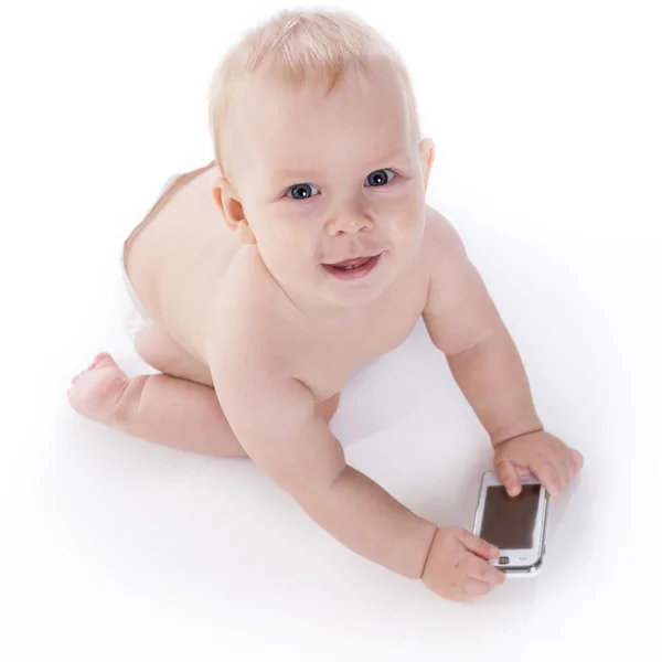 Sorridente bambino sta imparando ad affrontare un telefono — Foto Stock