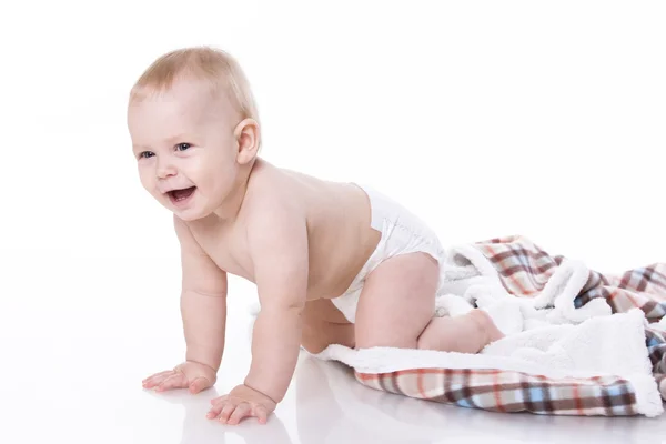 Smiling baby playing on plaid — Stock Photo, Image