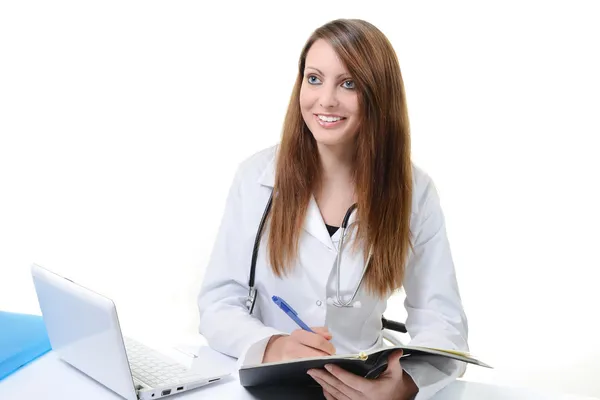 Student kvinnliga läkare skriver i en planner Royaltyfria Stockbilder
