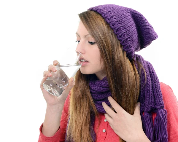 Close-up of sick pretty girl drinking water from glass — Stock Photo, Image