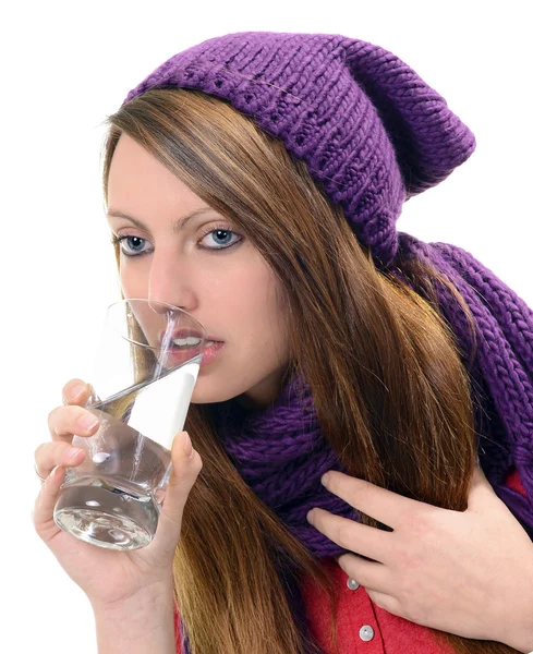 Close-up of sick pretty girl drinking water from glass — Stock Photo, Image