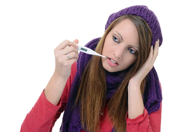 Pretty young girl using a thermometer in her mouth — Stock Photo, Image