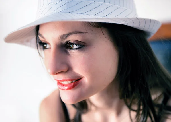 Portrait of sensual smiling woman with white hat seat on a chair — Stock Photo, Image