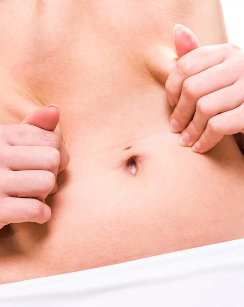 Close up female pinching skin of her belly — Stock Photo, Image