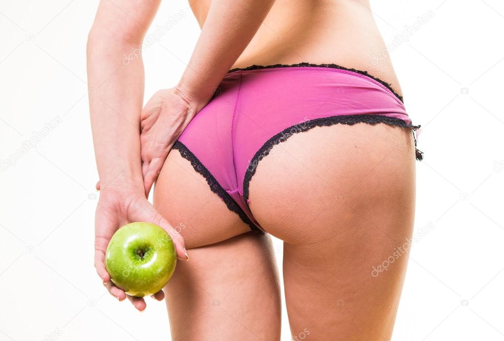 female with perfect buttocks and apple in hand
