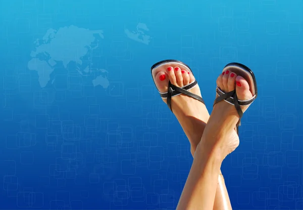 Feet crossed with blue world map in background — Stock Photo, Image