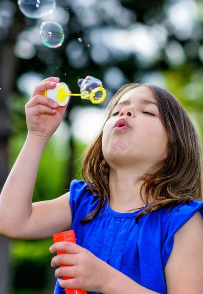 Beautiful child blowing bubbles — Stock Photo, Image