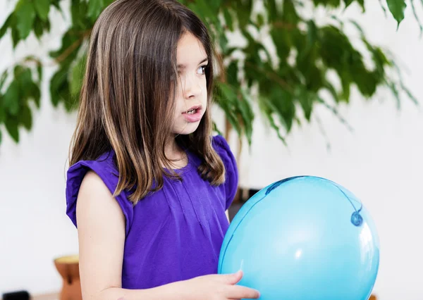 Portrait of very cute girl playing with a blue balloon — Stock Photo, Image