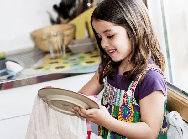 Retrato expressivo de menina muito bonito limpando os pratos — Fotografia de Stock