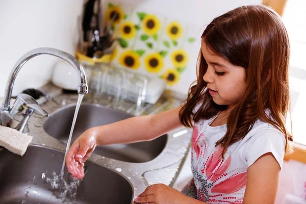 Expressive portrait of very cute girl washing hands — Stock Photo, Image