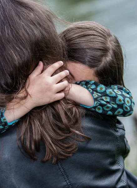 Expressive portrait of pretty girl hugging her mother — Stock Photo, Image