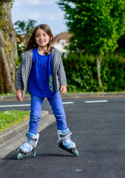 Bella bambina che fa roller blade in strada — Foto Stock