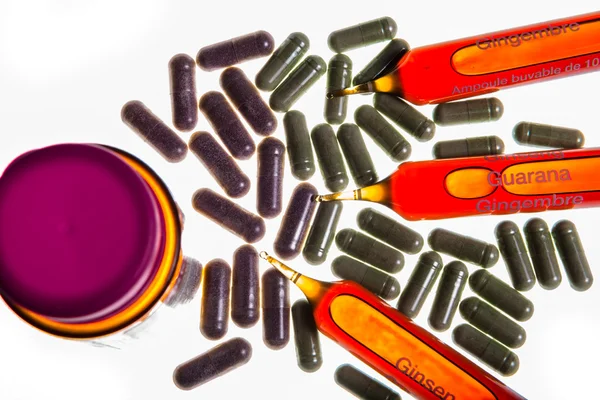 Close up of vitamin ampuls and natural pills — Stock Photo, Image