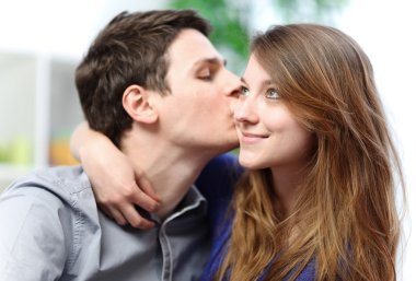 Handsome young man embracing his girlfriend with love