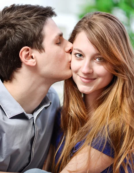 Handsome young man embracing his girlfriend with love — Zdjęcie stockowe