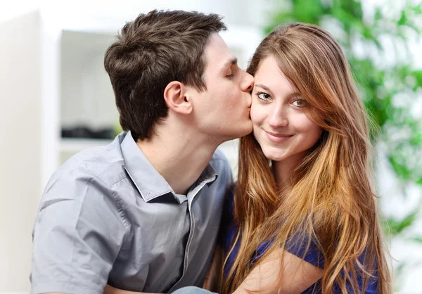 Handsome young man embracing his girlfriend with love — Zdjęcie stockowe