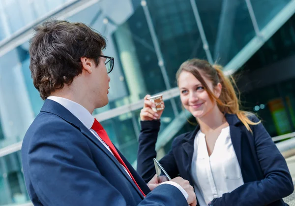 Junior executives having a coffee break in front of their company — Stock Photo, Image