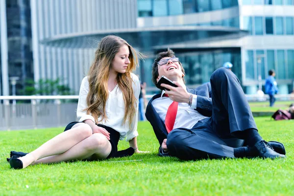 Successful Junior executives dynamics laying down on green grass — Stock Photo, Image