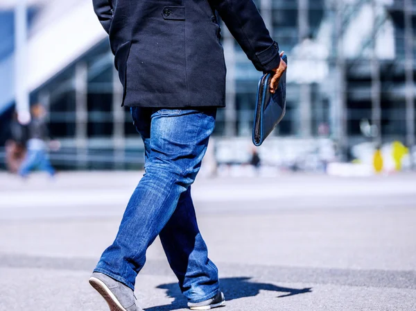 Worker man walking with suitcase in the street — Stock Photo, Image