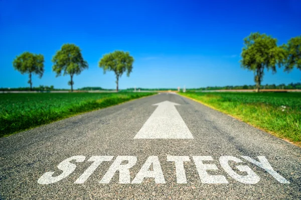 Strategy word painted on asphalt road — Stock Photo, Image