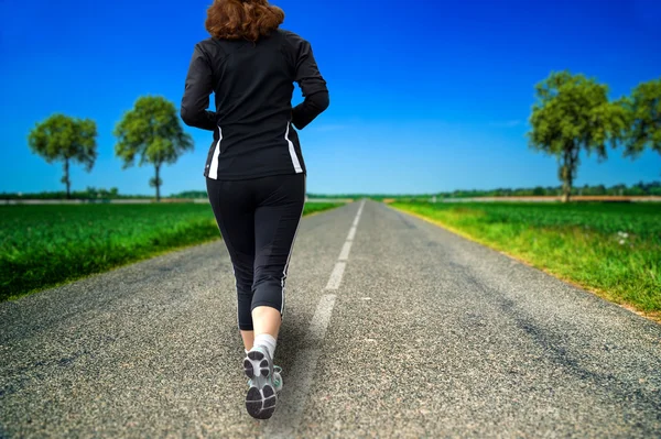 Running woman on the road — Stock Photo, Image