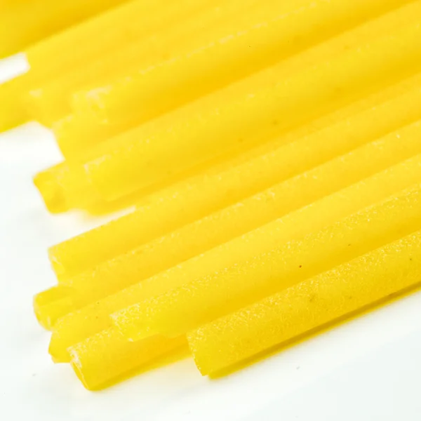 Uncooked Italian spaghetti on a white background — Stock Photo, Image