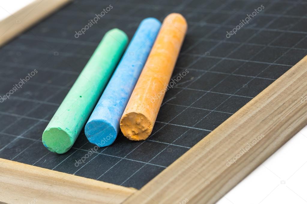 Colored chalk placed on a school slate Stock Photo by ©Pixinooo 50483427
