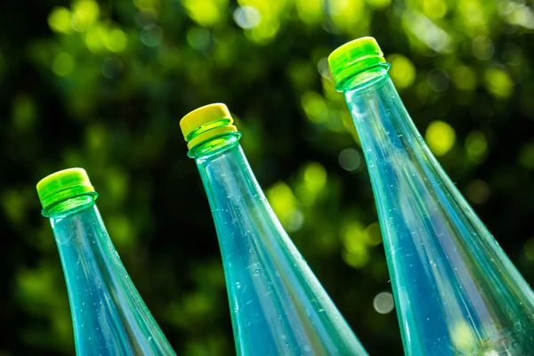 Bottles isolated on nature background — Stock Photo, Image